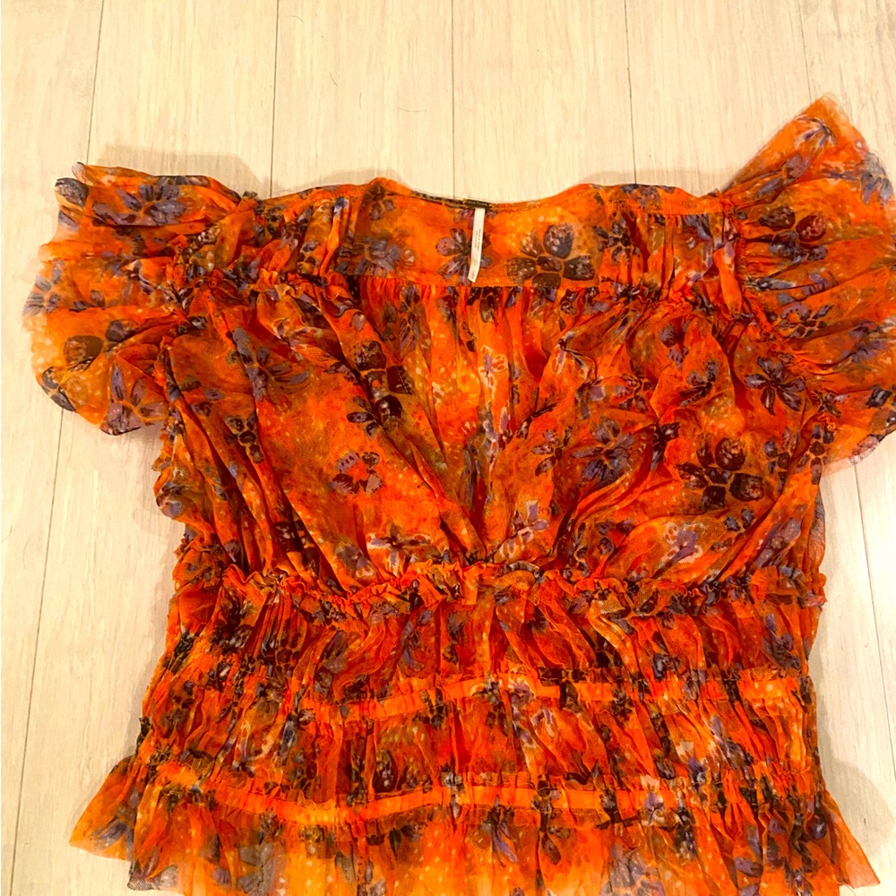 Free people top. Size large but runs small. Slightly cropped.